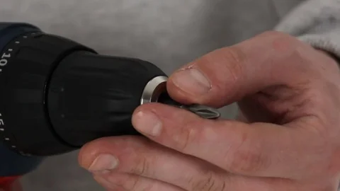 Man's hands close-up inserts bit into the drill Stock Footage 69912967