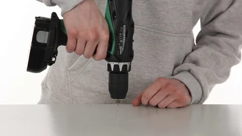Man's hands close-up making a hole in the tabble with the drill Stock-Footage 69910120