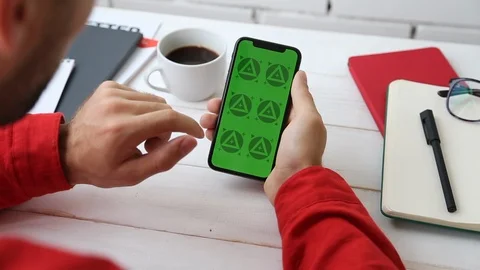 Man's Hands Close Up of Phone With Green Screen on White Office Wooden Table Stock Footage 109604531