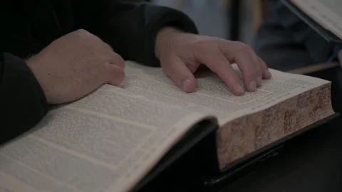 Mans hands close up Reading religious book Stock Footage 246256617