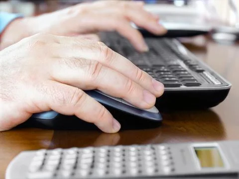 Man's Hands on Computer Mouse and Keyboard Stock Photos