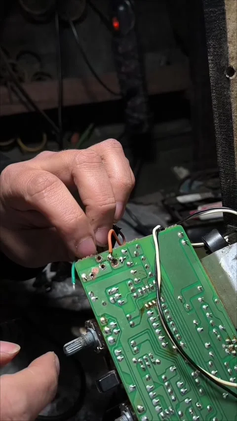 A man's hands connecting and soldering electrical wires Stock Footage 345082391