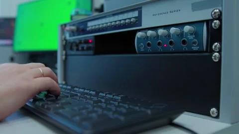 A man's hands controlling a mixer and typing on a keyboard Stock Footage 271358728