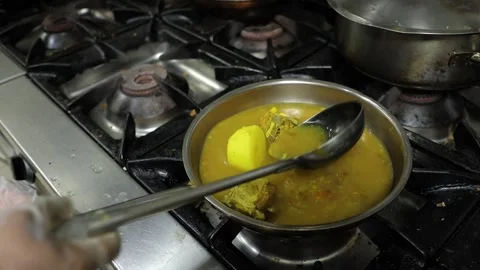 Man's hands cooking and stewing potatoes and fish in a frying pan. Stock Footage 201249845