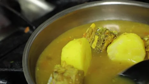 Man's hands cooking, stewing potatoes and fish in a frying pan, close up. Stock Footage 201249858