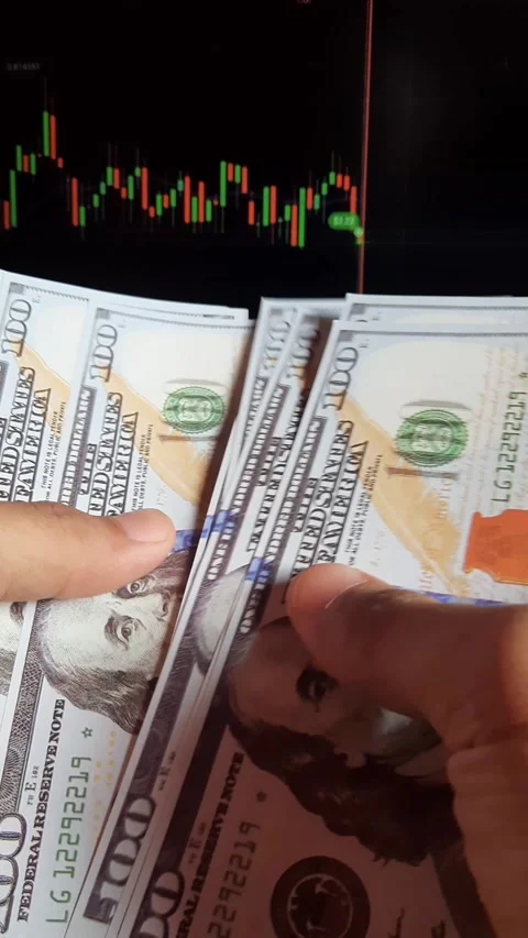 Man's hands count dollar bills on the background of a laptop Stock Footage 289201434