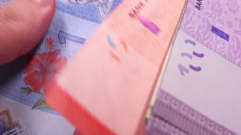 Man's hands counting brand new Malaysian ringgit (MYR). Close up view. Stock Footage 296429505