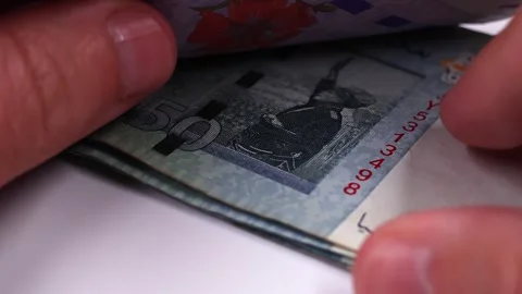 Mans hands counting brand new Malaysian ringgit (MYR) banknotes. Stock Footage 300032890