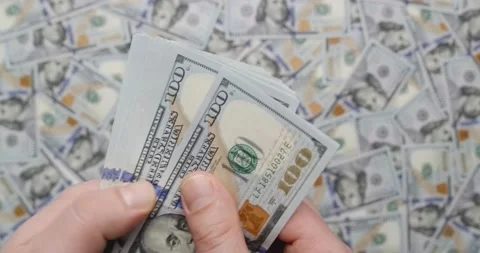 Man's hands counting hundred dollars bills with money on background Stock Footage 134148684