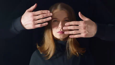 The man's hands cover the woman's face. Violence concept Stock Footage 167077901