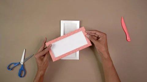 Man's hands creating DIY paper window envelope with craft tools on table top Stock Footage 344458717