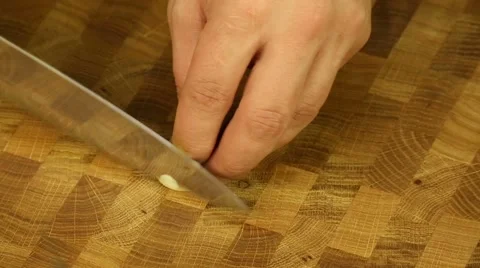 Man's hands crushed and chopped garlic Stock Footage 57523604