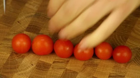 Man's hands cut cherry tomatoes Stock Footage 52942768