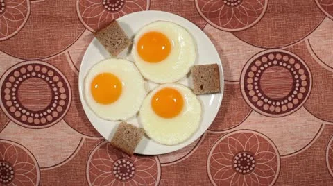 Man's hands cut fried eggs Stock Footage 10825222