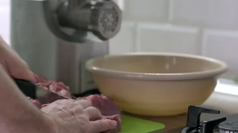 Mans hands cut raw meat with the knife in the kitchen. Preparation of minced Stock Footage 165054124