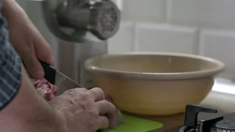 Mans hands cut raw meat with the knife in the kitchen. Preparation of minced Video stock 165252738