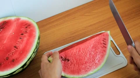 Man's hands cut ripe fragrant watermelon into slices Stock Footage 55779854