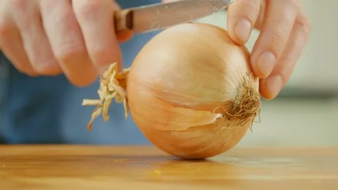 Man's Hands Cutting And Peeling Onion On Chopping Board Stock Footage 86069106