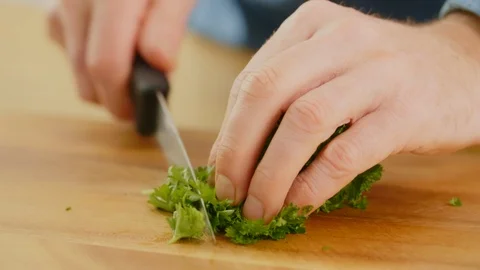 Man's Hands Cutting Cilantro With Knife On Chopping Board Stock Footage 86069832