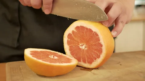 Man's hands cutting fresh orange Stock Footage 89833539