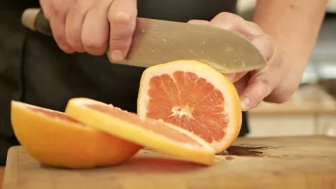 Man's hands cutting fresh orange Stock Footage 89848294