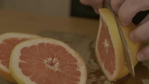 Man's hands cutting fresh orange Stock Footage 90232682