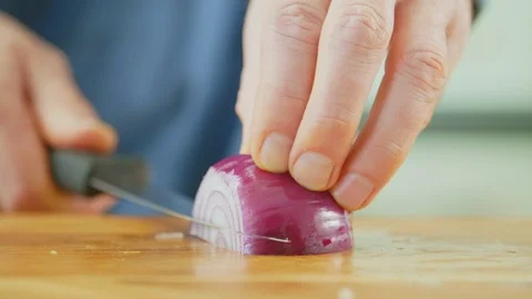 Man's Hands Cutting Onion With Sharp Knife On Chopping Board Stock Footage 86069188