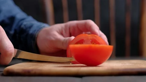 Man's hands cutting tomato Stock Footage 187497086