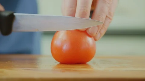 Man's Hands Cutting Tomato With Knife On Chopping Board Stock Footage 86069259