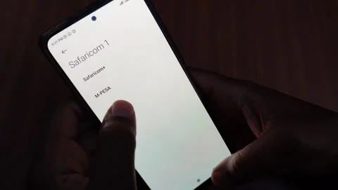 A Man's Hands in the Dark Buying Kplc Tokens Using Mpesa Playbill Number Stock Footage 255653628