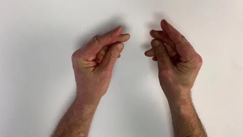 Mans hands doing a continuous, snapping gesture or rubbing fingers together. Stock Footage 333471112