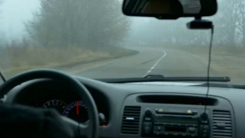 Man's hands of a driver on steering wheel of a car on asphalt road Stock-Footage 73661313