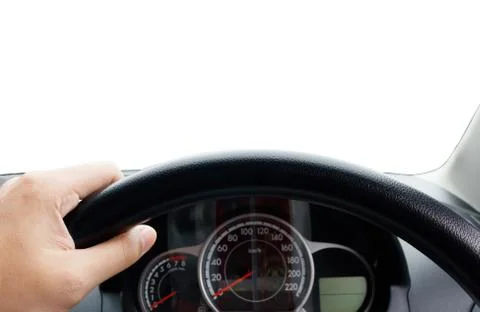 Man's hands of a driver on steering wheel of a minivan car on asphalt road,.. Stock Photos