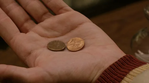 Man's hands dropping change into a jar Stock Footage 127961656