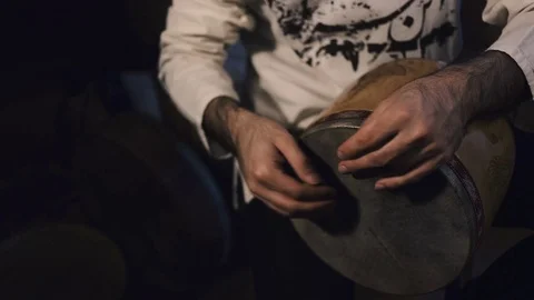 Man's hands drumming out a beat on an arabic percussion drum named Tombak Stock-Footage 74522679