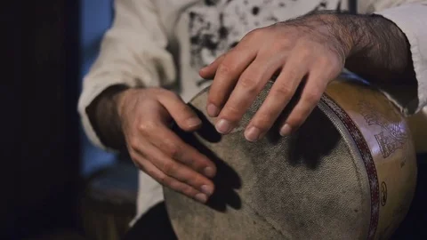 Man's hands drumming out a beat on an arabic percussion drum named Tombak Stock Footage 74523541