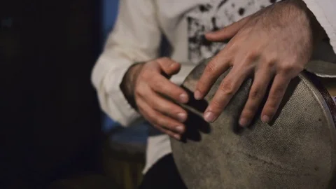 Man's hands drumming out a beat on an arabic percussion drum named Tombak Video stock 74523602