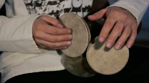 Man's hands drumming out a beat on an arabic percussion drum named Kasoureh Video stock 84772480