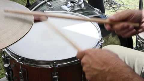 Man's hands with drumsticks playing the drums outdoors. Video stock 197291274