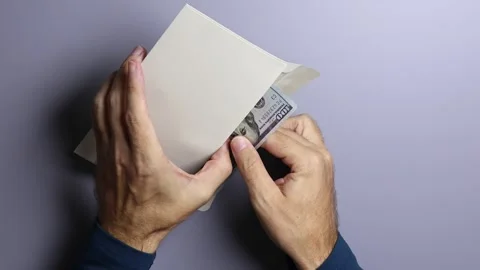 Man's hands, envelope and American dollars (USD) cash money banknotes. Stock Footage 303341106