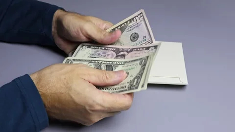 Man's hands, envelope and American dollar (USD) cash money banknotes. Stock Footage 303366716
