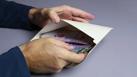 Man's hands, envelope and Malaysian ringgit (MYR) cash money banknotes. Stock Footage 303371423