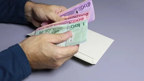 Man's hands, envelope and Thai baht (THB) cash money banknotes. Stock Footage 303375145