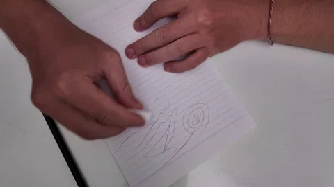 The man's hands erase the lines drawn with a pencil. 스톡 동영상 331124452