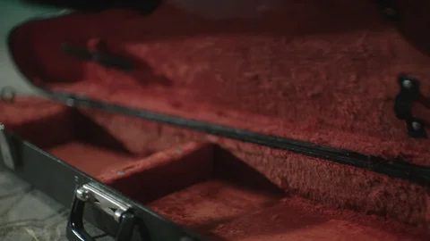Man's hands folding violin into case and takes away. Stock Footage 107793828