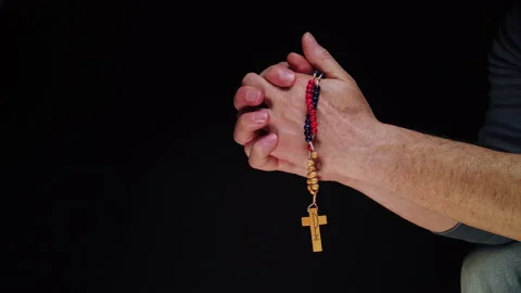 A man's hands grasping and holding a rosary Stock Footage 224927079