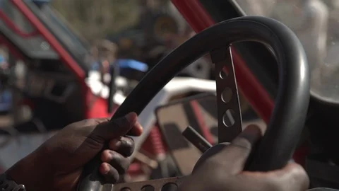 A man's hands grip a dusty and worn wheel of an All-Terrain vehicle Stock Footage 89664862