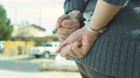 Mans hands in hand cuffs Stock Footage 104345722