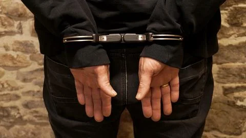 Man's hands in handcuffs Stock Photos