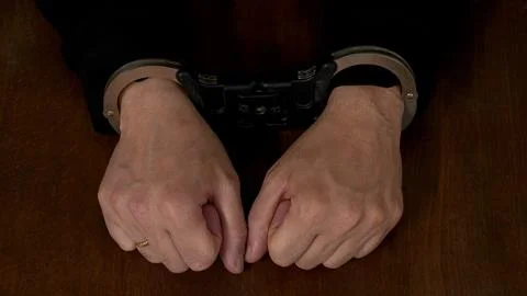 Man's hands in handcuffs Stock Photos